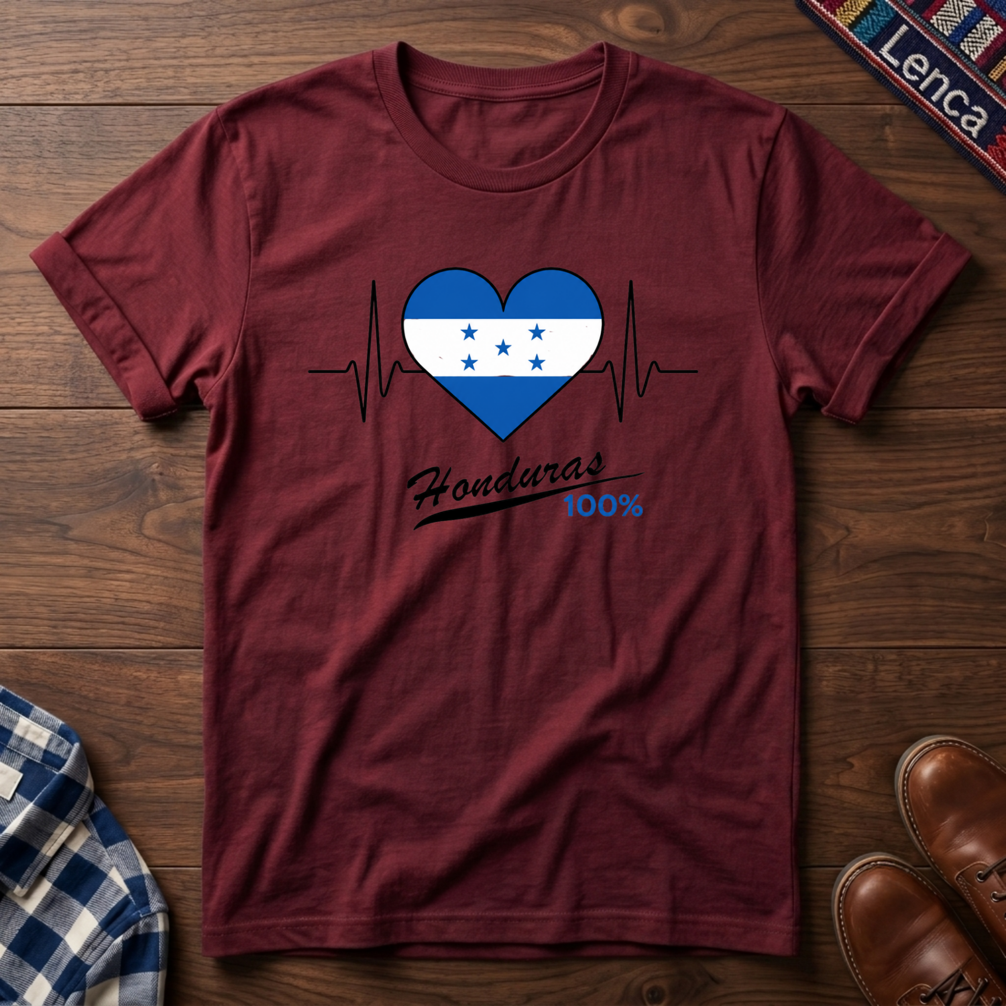 Cherry red t-shirt with a heart design featuring Honduras' flag and 'Honduras 100%' text on a wooden surface.