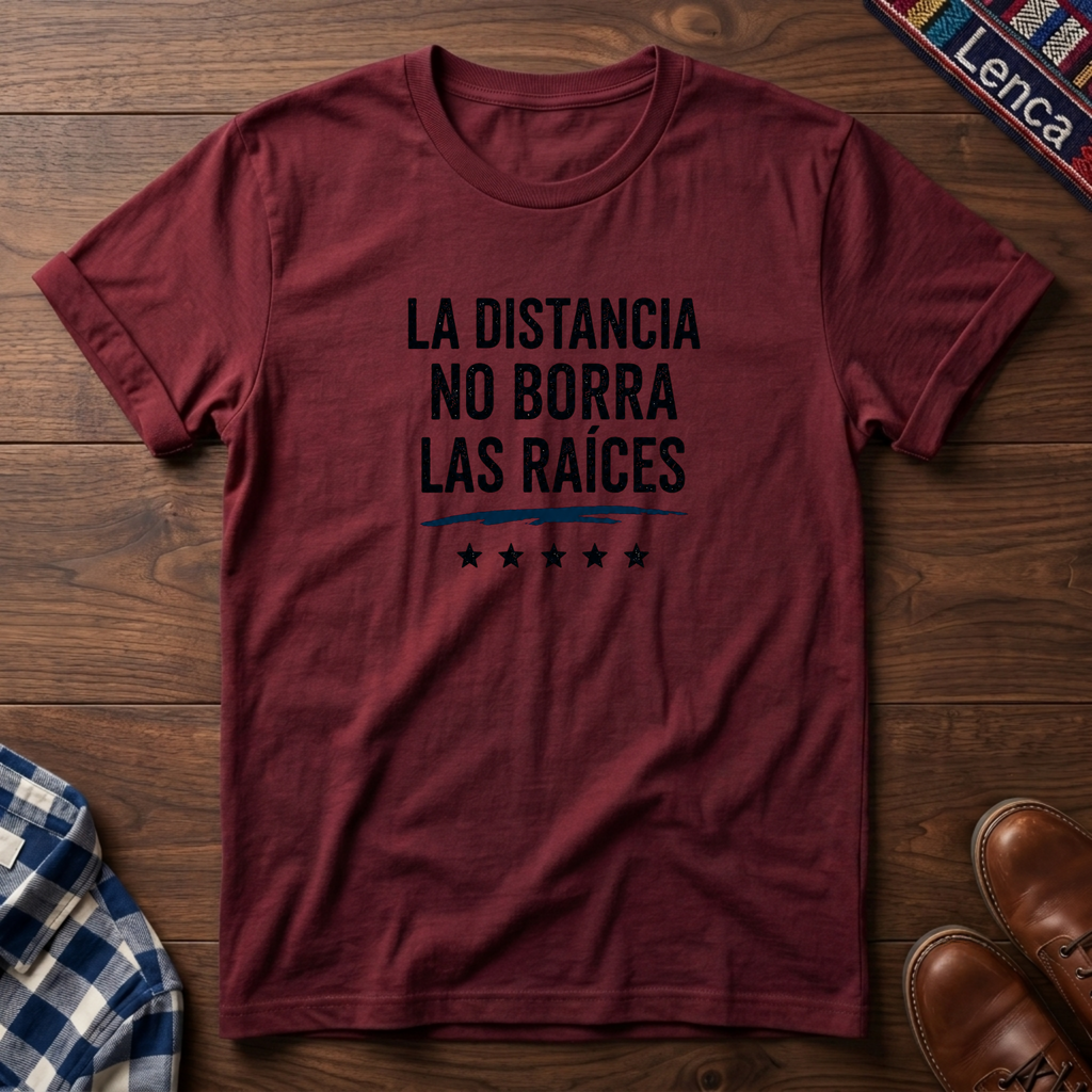 Cherry red t-shirt with 'La Distancia' text on a wooden surface.
