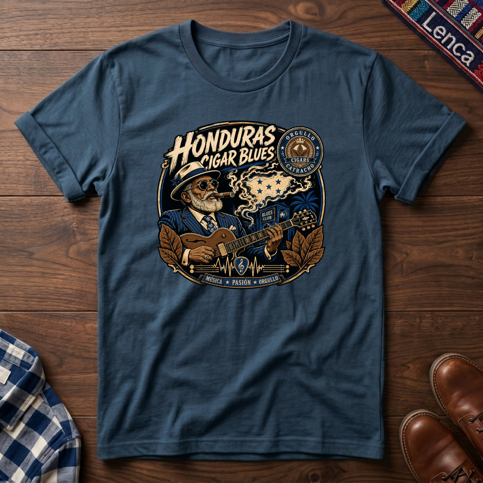 Indigo blue t-shirt with 'Honduras Cigar Blues' graphic on a wooden surface.