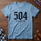 Light blue t-shirt with '504 Catracho' text on a wooden surface.