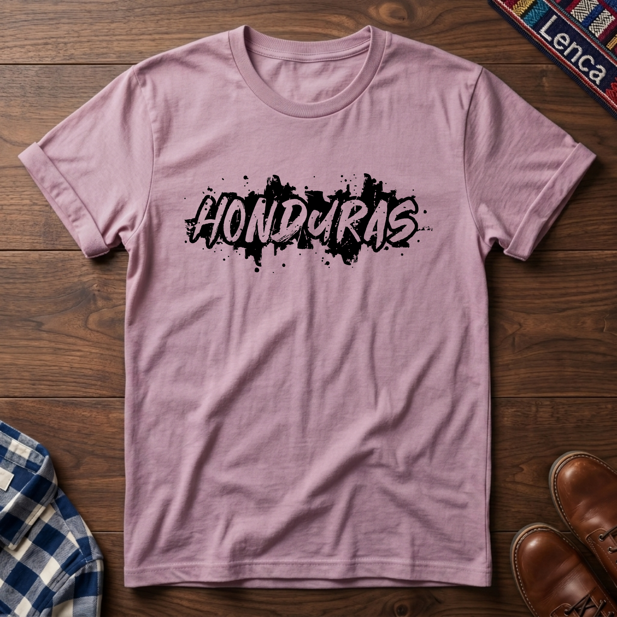 Light pink t-shirt with 'Honduras' print on a wooden surface
