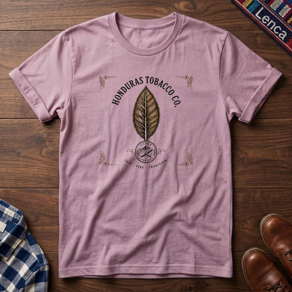 Light Pink t-shirt with 'Honduras' text and leaf graphic on a wooden surface.
