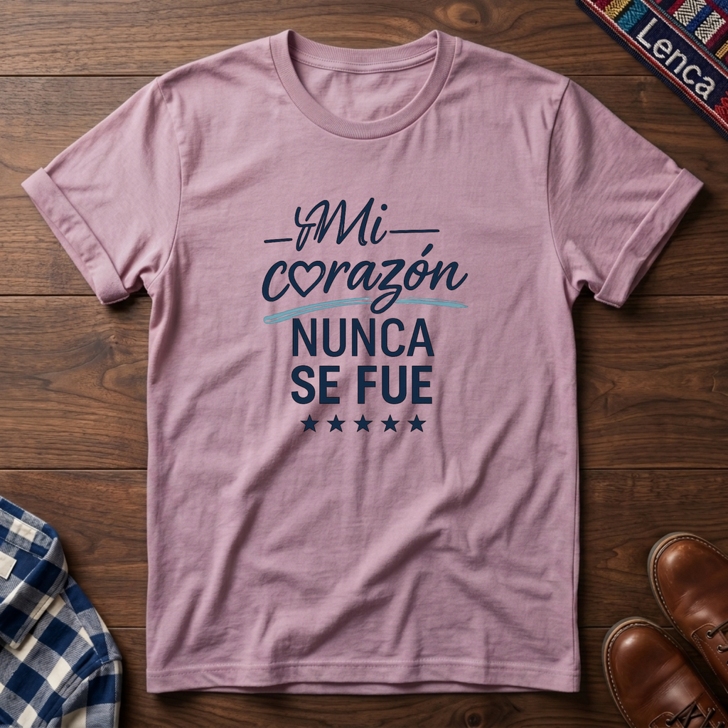 Light pink t-shirt with 'Mi Corazon Nunca' text on a wooden surface.