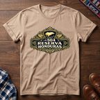 Natural t-shirt with 'La 504 Reserva Honduras' graphic design on a wooden surface.