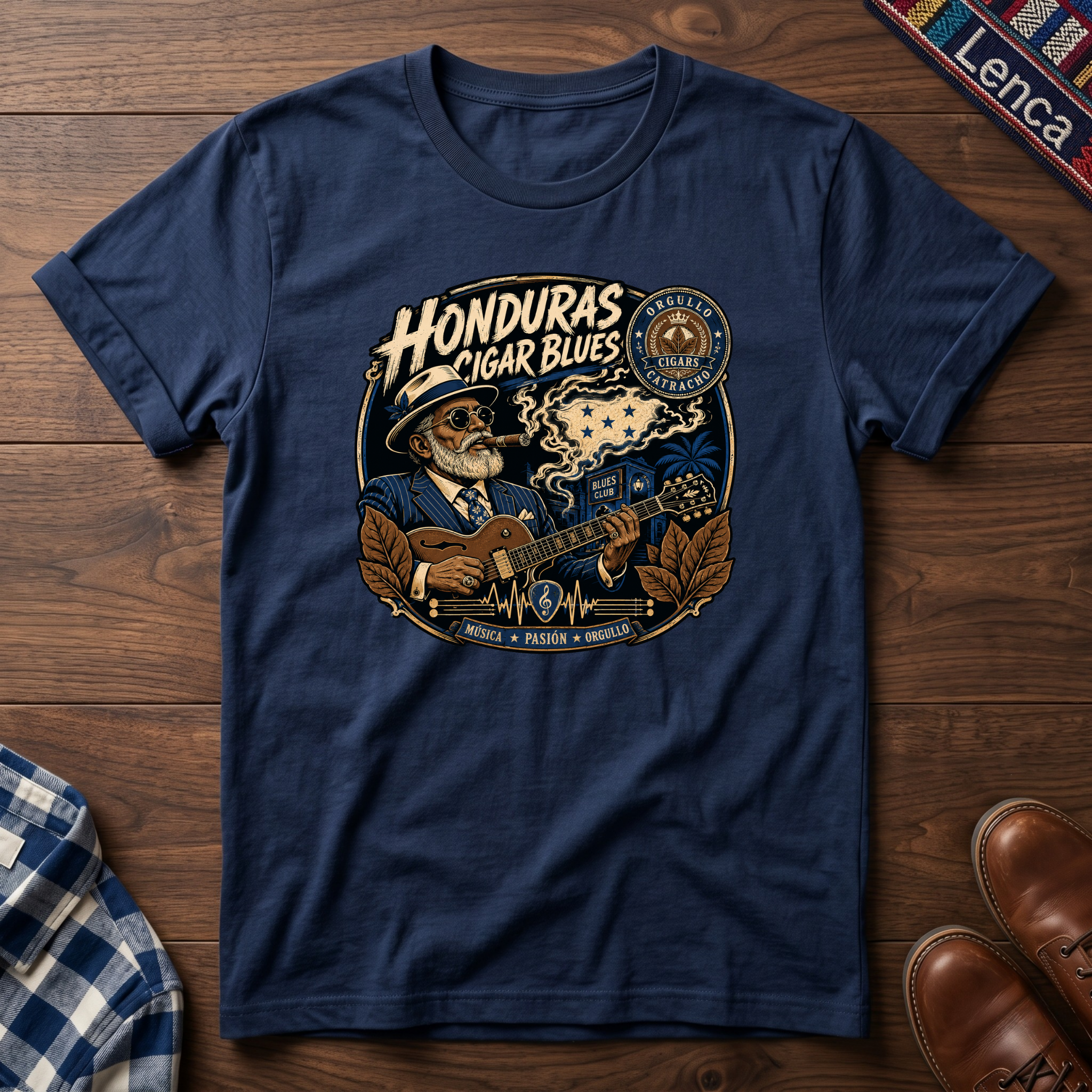 Navy blue t-shirt with 'Honduras Cigar Blues' graphic on a wooden surface.