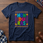 Navy t-shirt with colorful 'Honduras' text on a wooden surface.