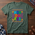 Sage t-shirt with colorful 'Honduras' text on a wooden surface.