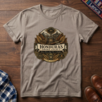 Sand t-shirt with 'Honduras Smoke Legacy' graphic on a wooden surface.