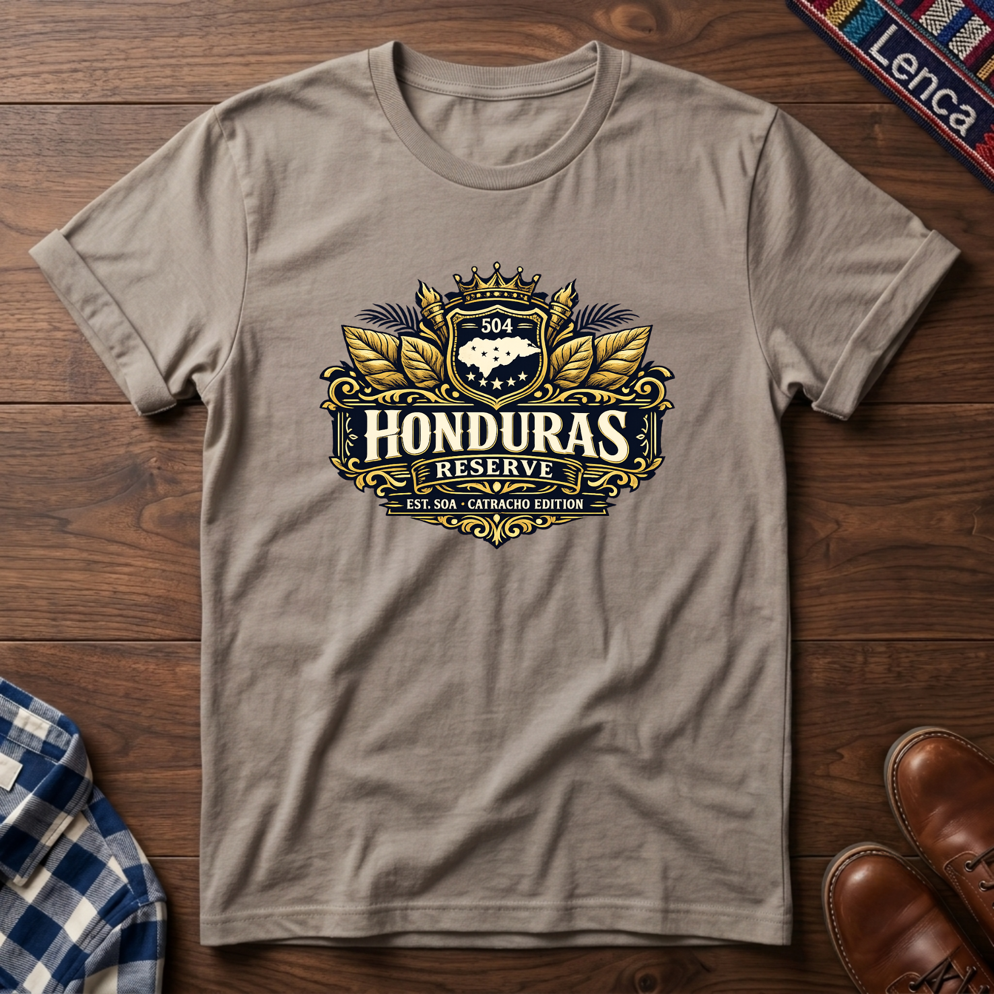 Sand t-shirt with a 'Honduras Reserve' graphic design on a wooden surface.