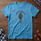 Sky t-shirt with 'Honduras' text and leaf graphic on a wooden surface.