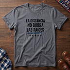 Sport Gray t-shirt with 'La Distancia' text on a wooden surface.