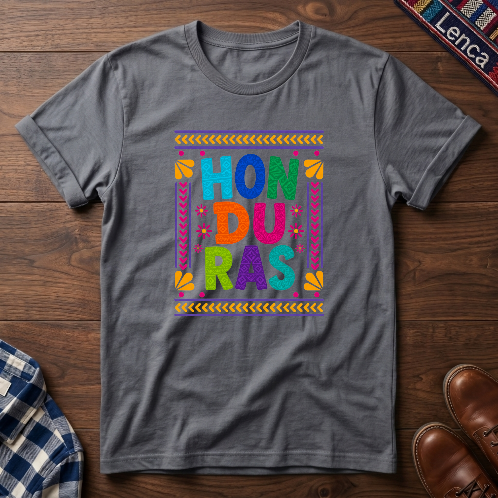 Sport gray t-shirt with colorful 'Honduras' text on a wooden surface.