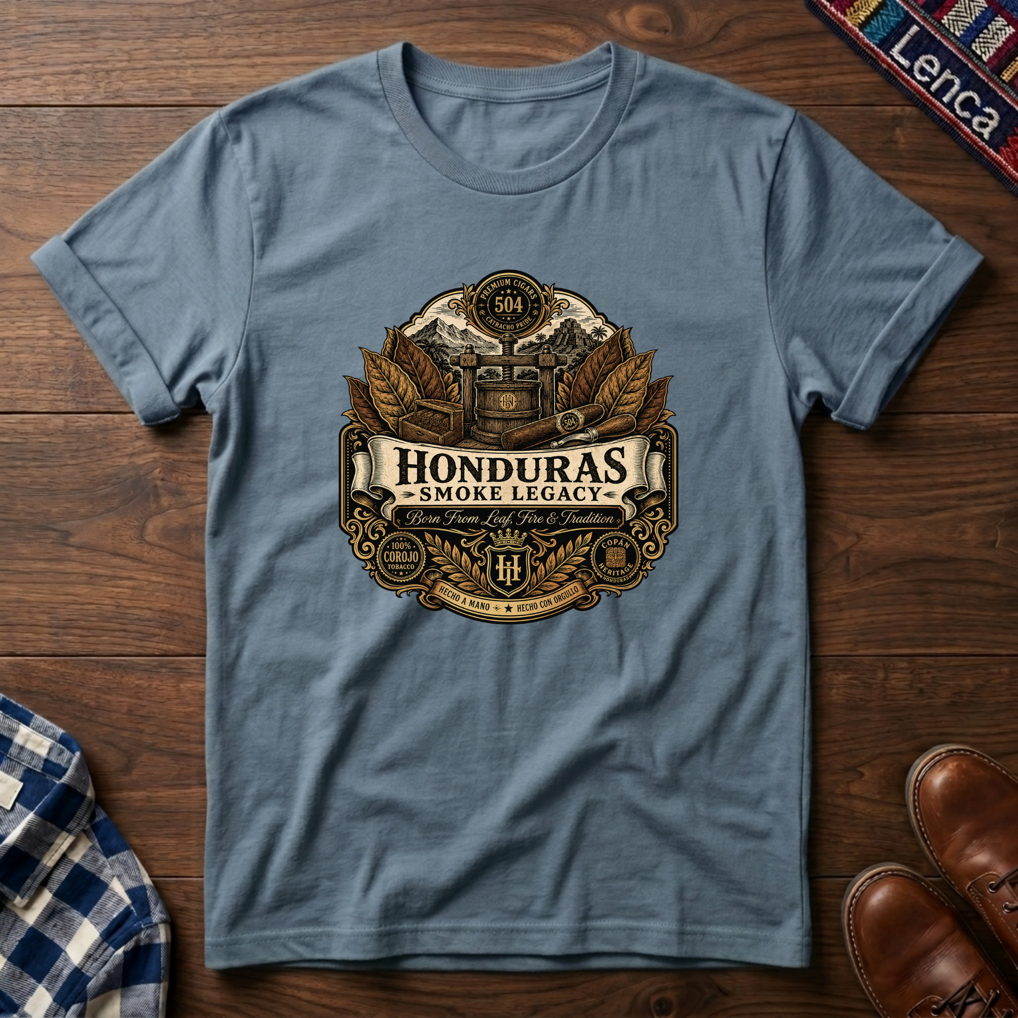 Stone blue t-shirt with 'Honduras Smoke Legacy' graphic on a wooden surface.