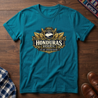 Tropical blue t-shirt with a 'Honduras Reserve' graphic design on a wooden surface.