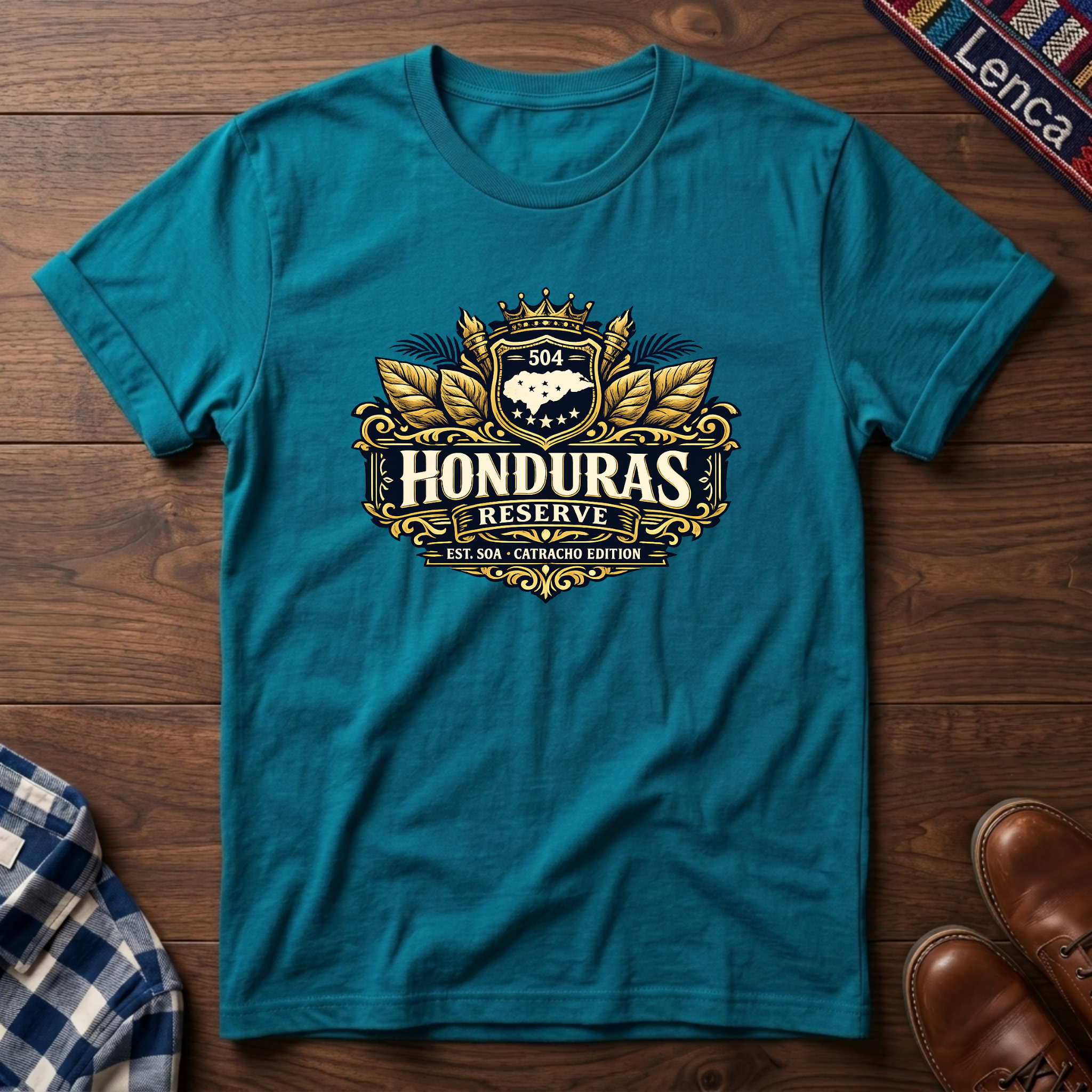 Tropical blue t-shirt with a 'Honduras Reserve' graphic design on a wooden surface.