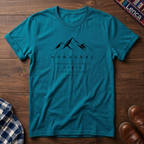 Blue t-shirt with mountain design and 'Honduras' text on a wooden surface.