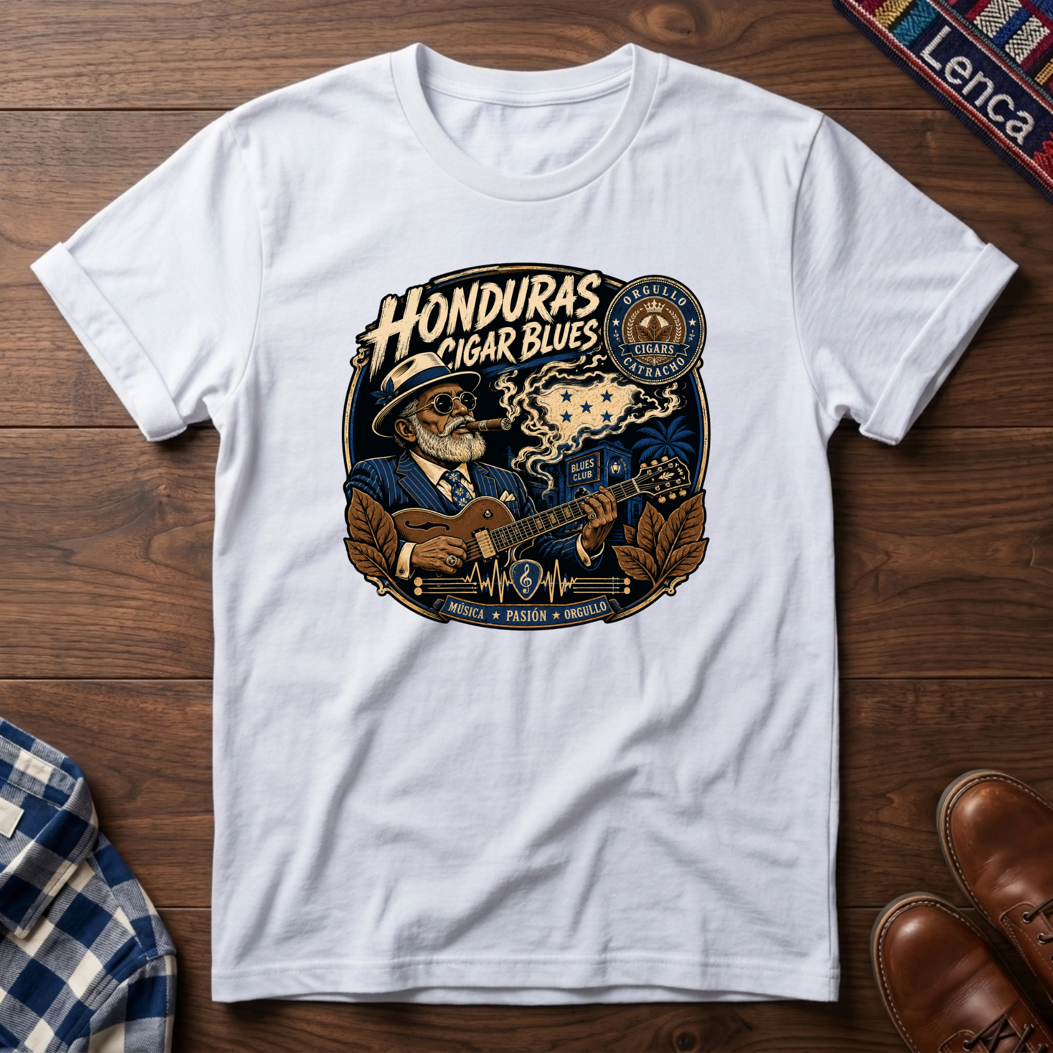 White t-shirt with 'Honduras Cigar Blues' graphic on a wooden surface.